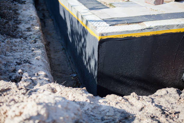 Professional Basement Waterproofing technician working in Oakley, MI